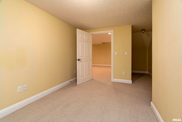 empty room featuring a textured ceiling and carpet floors