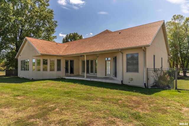 rear view of house with a lawn and a patio area