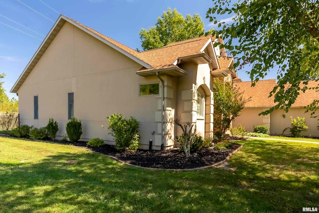 view of home's exterior with a lawn