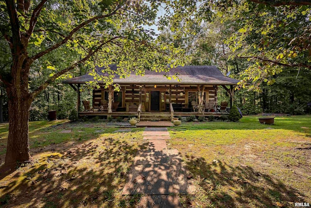 log home featuring a front lawn and covered porch