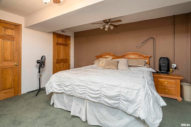 bedroom featuring ceiling fan and dark colored carpet