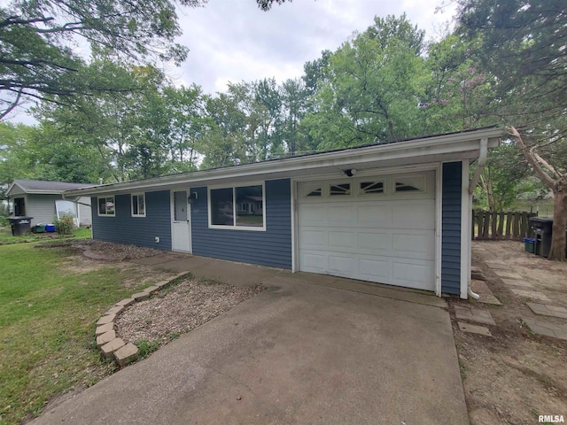 ranch-style house featuring a garage and a front lawn