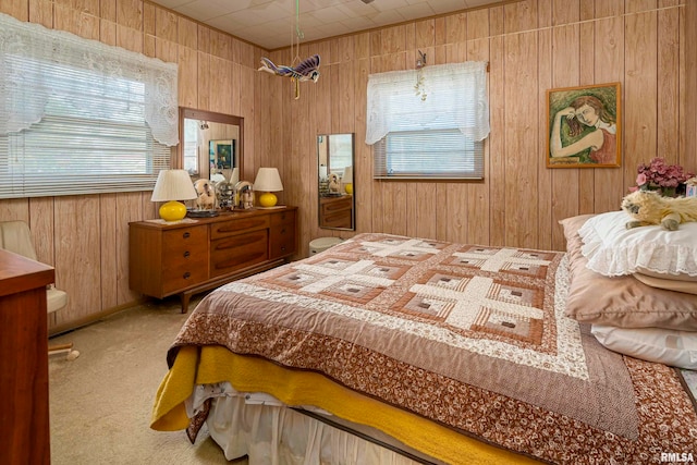 carpeted bedroom with wood walls