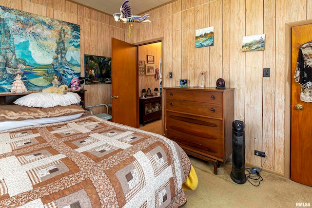 carpeted bedroom featuring wooden walls