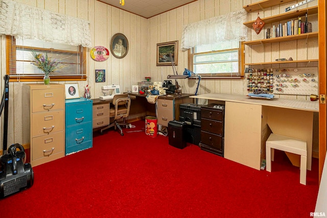 carpeted office space with built in desk and wooden walls