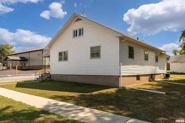 view of side of home with a lawn and central air condition unit