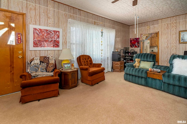 living room with ceiling fan and carpet