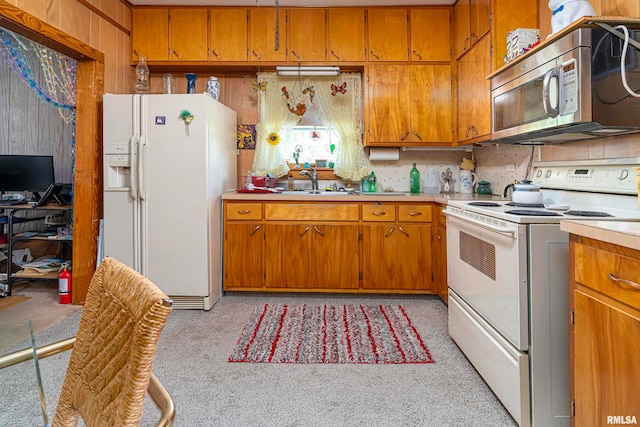 kitchen featuring range, sink, and white fridge with ice dispenser