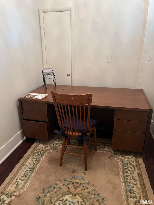 office space with dark wood-type flooring