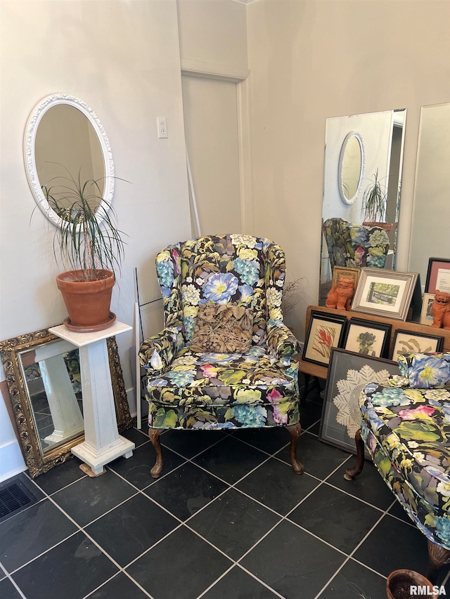 sitting room featuring dark tile patterned floors