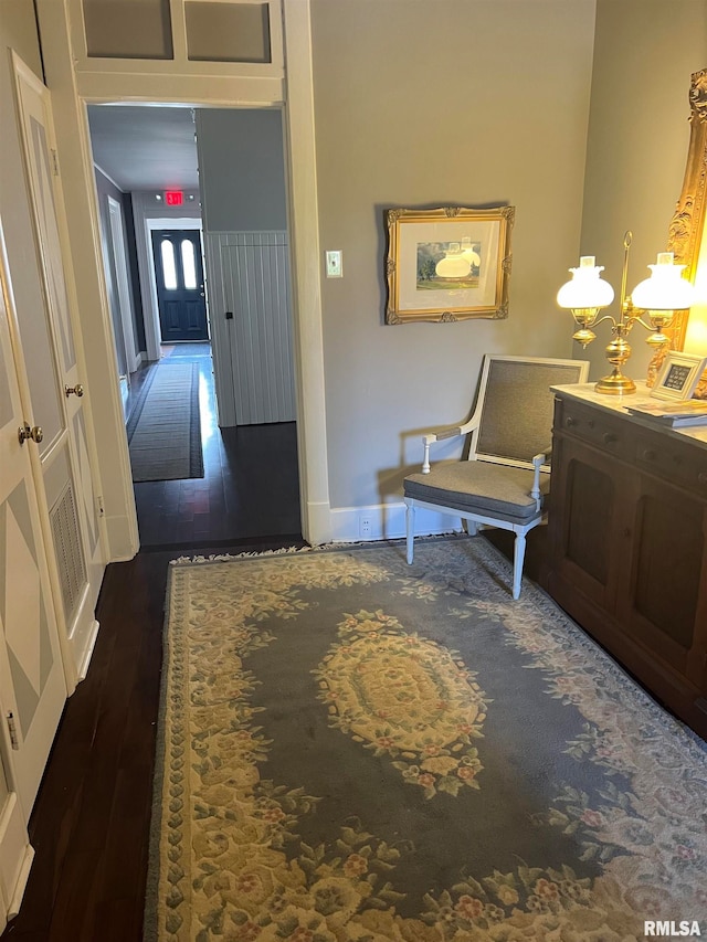 sitting room featuring a notable chandelier and dark hardwood / wood-style flooring