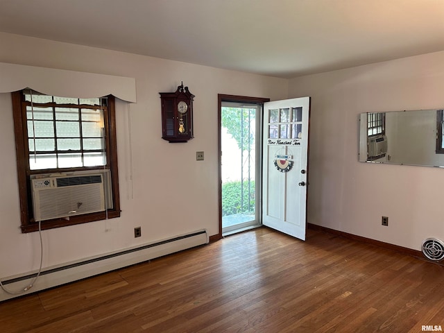 interior space with hardwood / wood-style floors and a baseboard heating unit