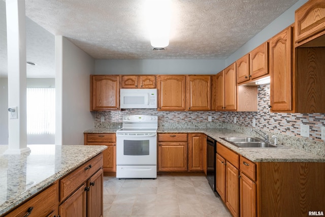 1500 Apache Dr, Marion, IL 62959 - kitchen with white appliances, a sink, brown cabinetry, a textured ceiling, and light stone counters