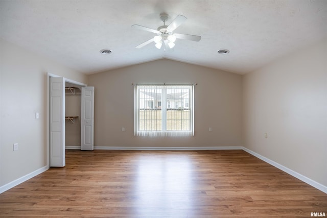 1500 Apache Dr, Marion, IL 62959 - unfurnished bedroom featuring lofted ceiling, light wood-type flooring, a walk in closet, baseboards, and a ceiling fan