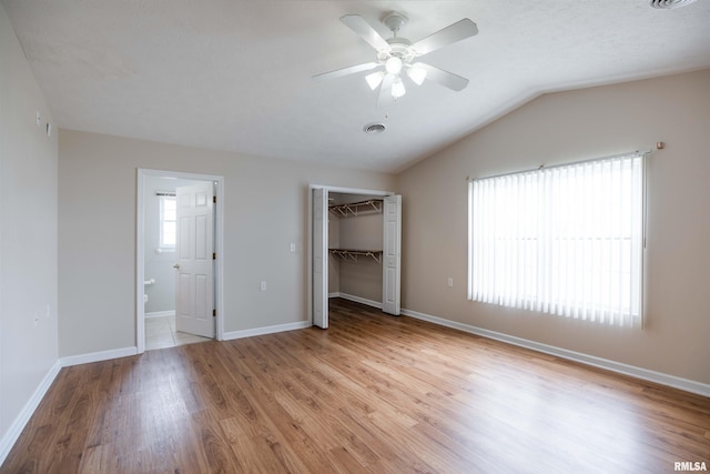1500 Apache Dr, Marion, IL 62959 - unfurnished bedroom featuring light wood-style floors, vaulted ceiling, baseboards, a ceiling fan, and connected bathroom