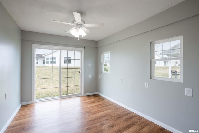 1500 Apache Dr, Marion, IL 62959 - spare room featuring wood finished floors, baseboards, healthy amount of natural light, and a textured ceiling