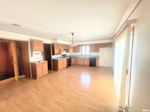 kitchen with black appliances, light wood-type flooring, sink, and hanging light fixtures