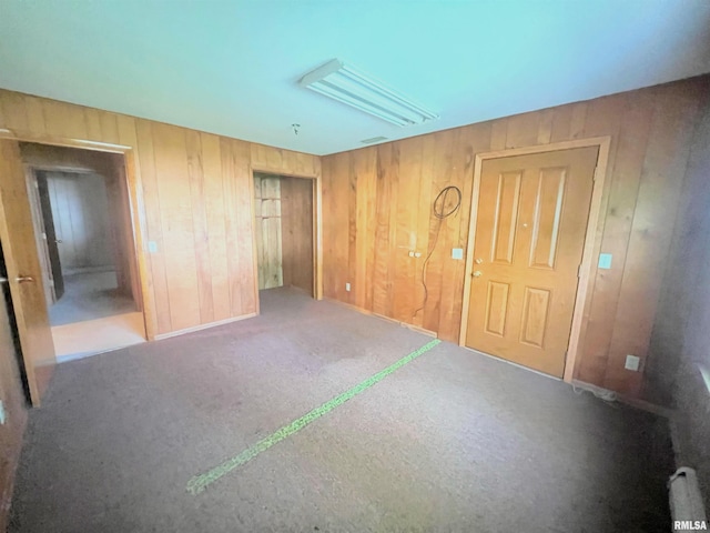 unfurnished bedroom featuring wooden walls