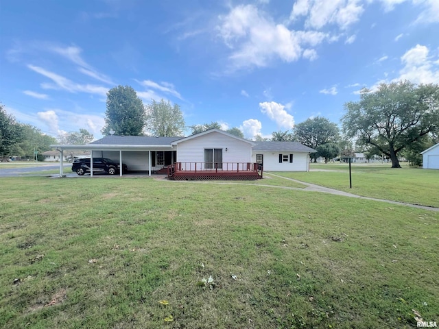 view of front of house featuring a wooden deck, a carport, and a front yard