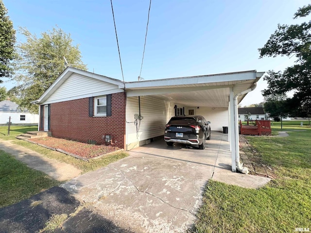 view of side of home with a yard and a carport