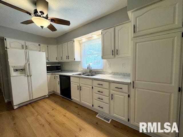 kitchen featuring dishwasher, ceiling fan, white fridge with ice dispenser, and white cabinets