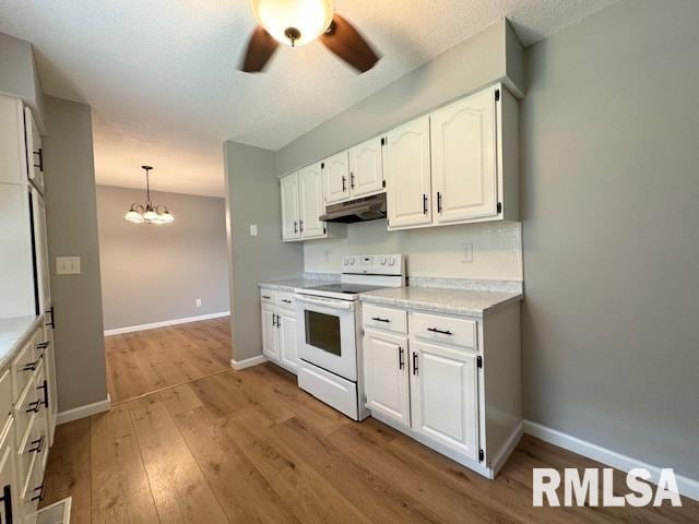 kitchen featuring decorative light fixtures, ceiling fan with notable chandelier, white electric range oven, light wood-type flooring, and white cabinets