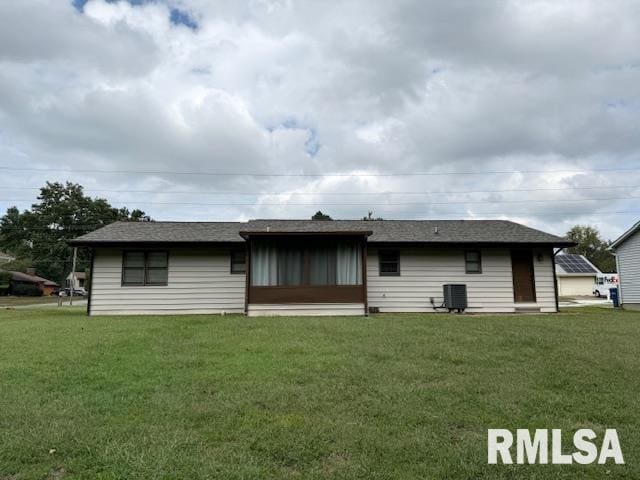 back of house featuring a yard and central AC unit