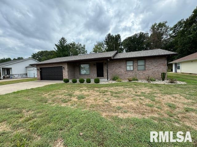 ranch-style home featuring a garage and a front lawn