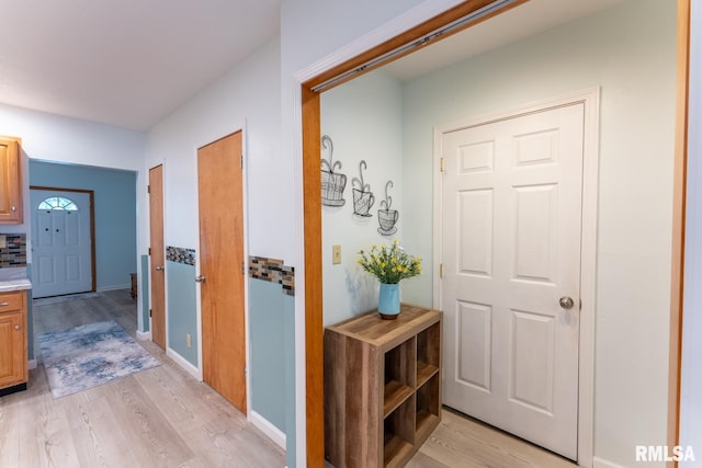 corridor with light hardwood / wood-style flooring