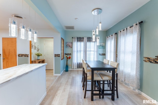 dining space with light wood-type flooring