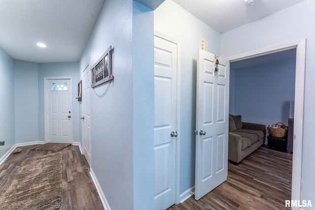 corridor with dark hardwood / wood-style floors