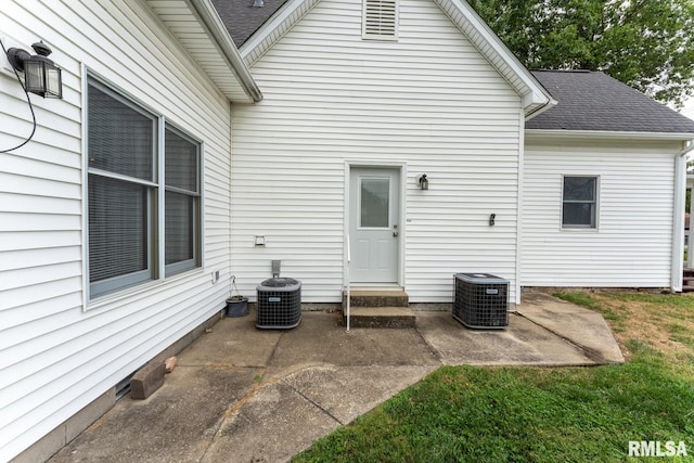 rear view of property featuring central AC unit and a patio area