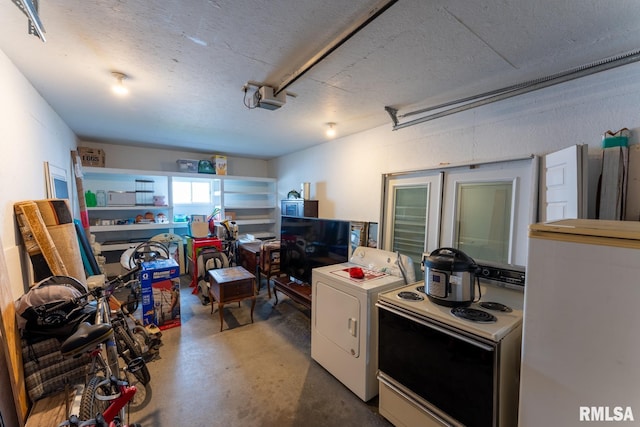 garage featuring a garage door opener and washer / dryer