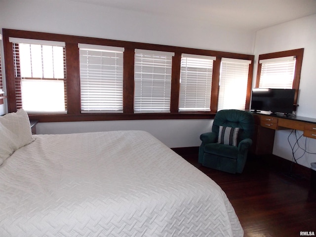 bedroom with dark wood-type flooring