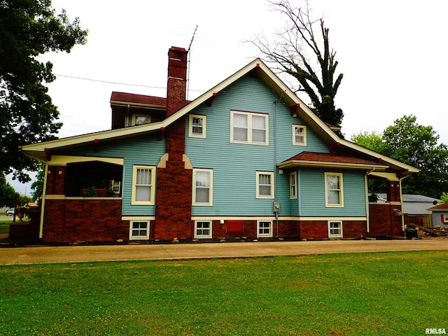 rear view of property with a yard