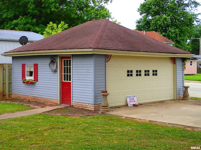 view of front of house with a front yard and a garage