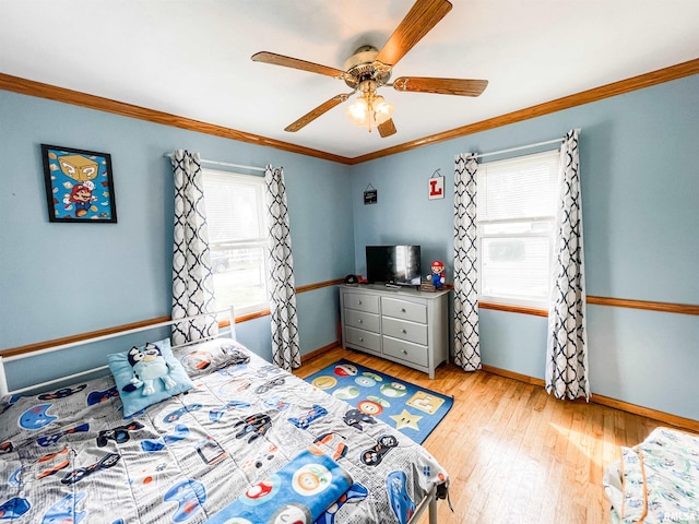 bedroom featuring ceiling fan, light hardwood / wood-style flooring, and crown molding