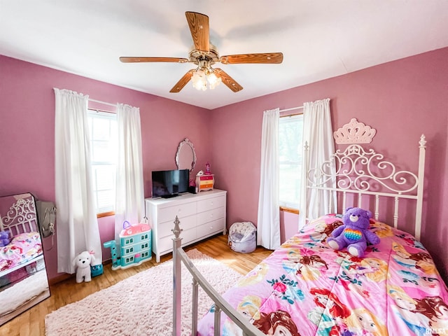 bedroom with light wood-type flooring and ceiling fan