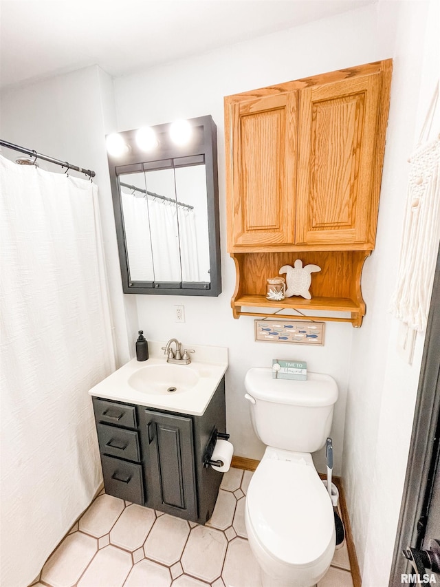 bathroom with tile patterned floors, a shower with curtain, vanity, and toilet