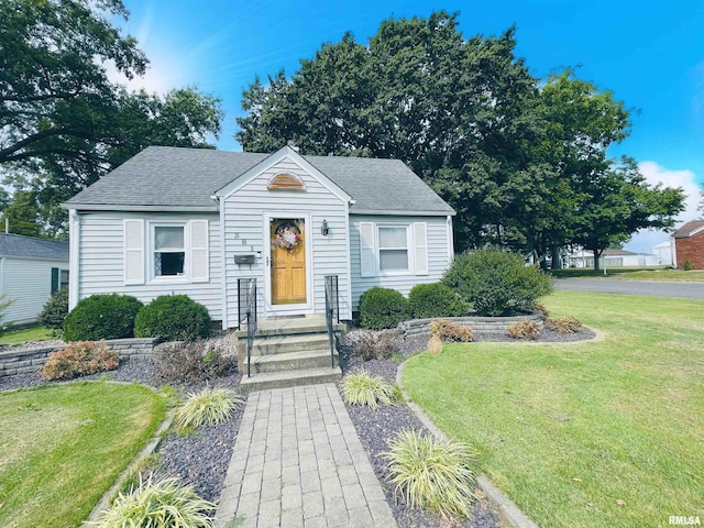 bungalow-style home with a front lawn