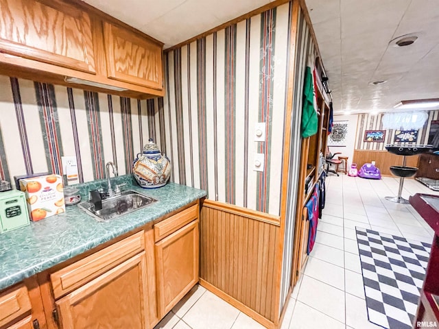 kitchen featuring light tile patterned flooring and sink