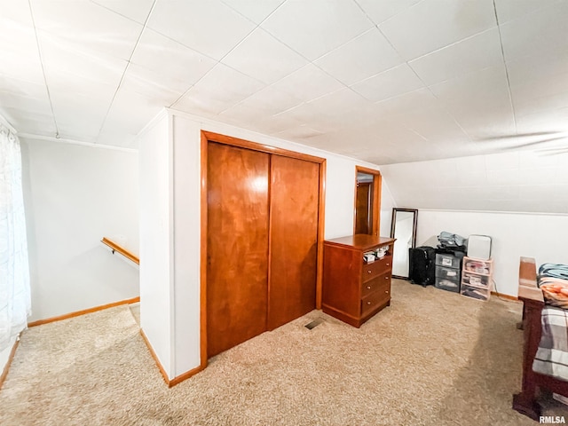 interior space featuring lofted ceiling and light colored carpet