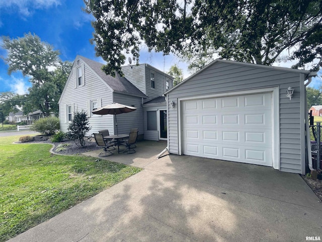 exterior space featuring a front lawn, an outdoor structure, and a garage