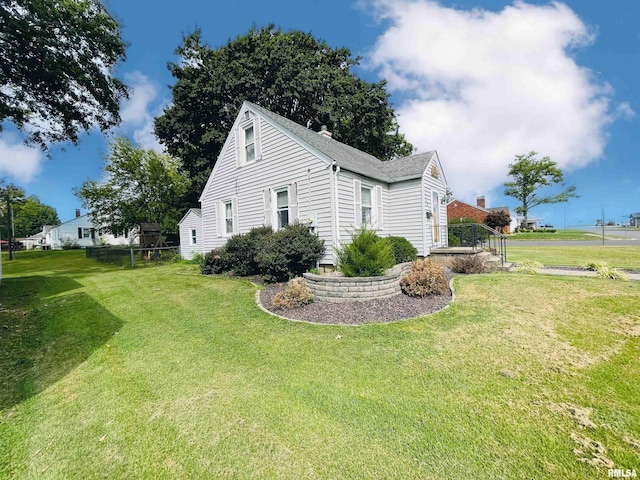 view of side of property with a yard