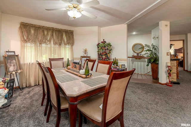 dining area with dark carpet and ceiling fan