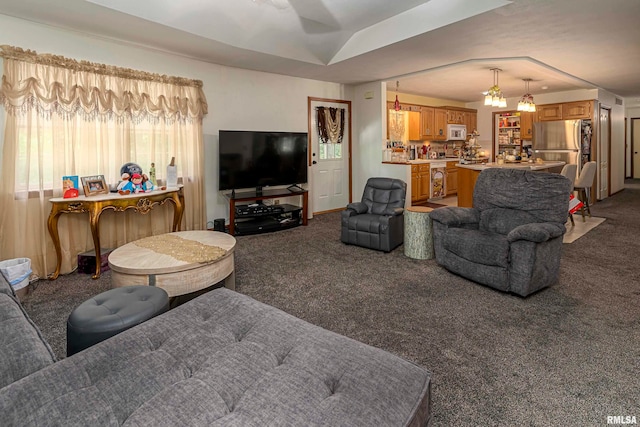 living room featuring carpet floors and a notable chandelier