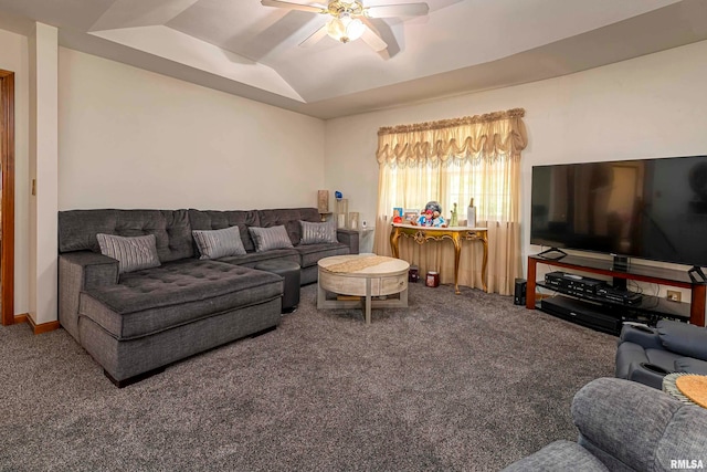 carpeted living room with a tray ceiling and ceiling fan