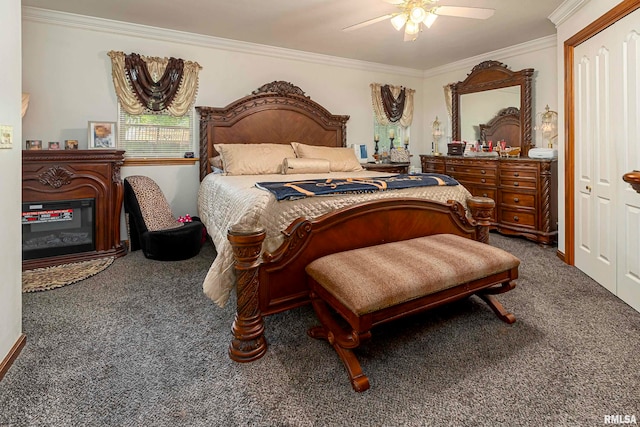 bedroom featuring ceiling fan, ornamental molding, a closet, and dark colored carpet