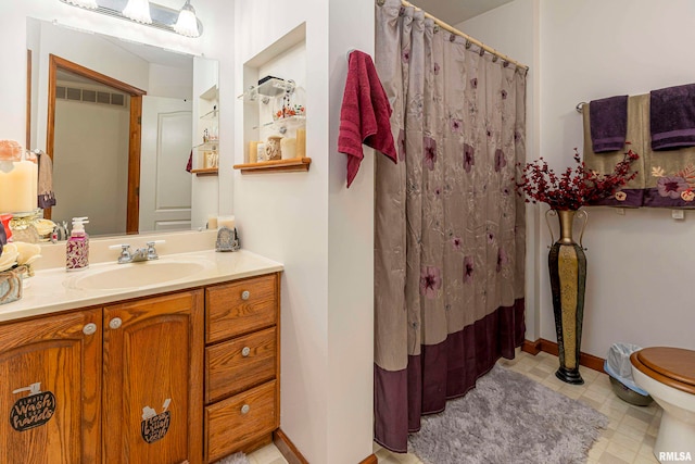 bathroom featuring vanity and toilet