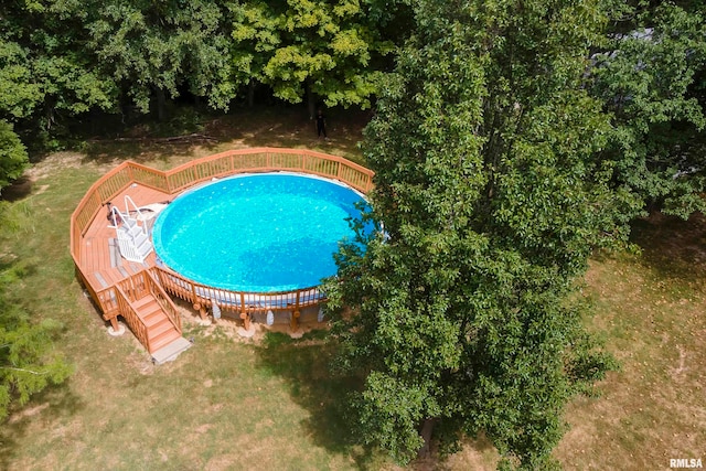 view of pool with a lawn